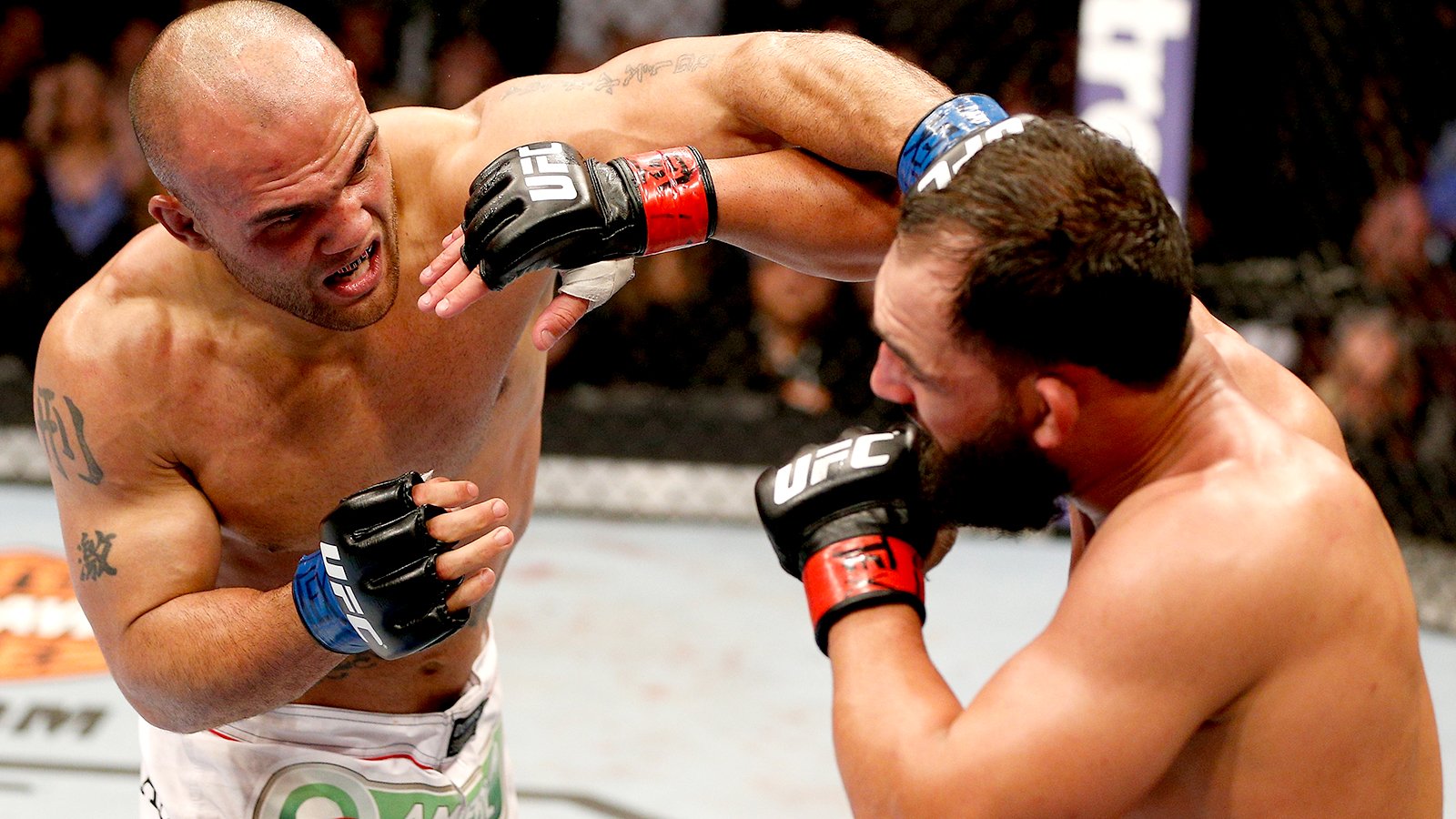 DALLAS, TX - MARCH 15: (L-R) Robbie Lawler punches Johny Hendricks in their UFC welterweight championship bout at UFC 171 inside American Airlines Center on March 15, 2014 in Dallas, Texas. (Photo by Josh Hedges/Zuffa LLC/Zuffa LLC via Getty Images) *** Local Caption *** Johny Hendricks; Robbie Lawler