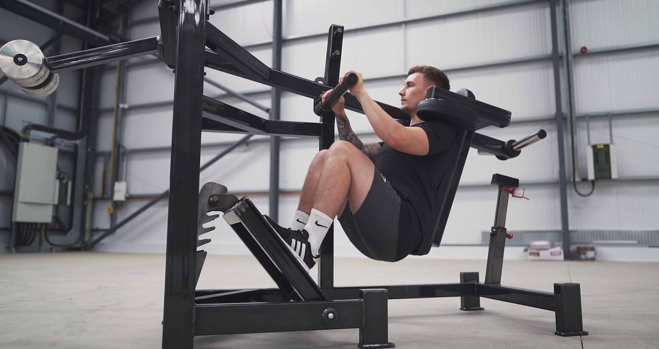 Premium Photo  Two focused strong gym partners doing squats