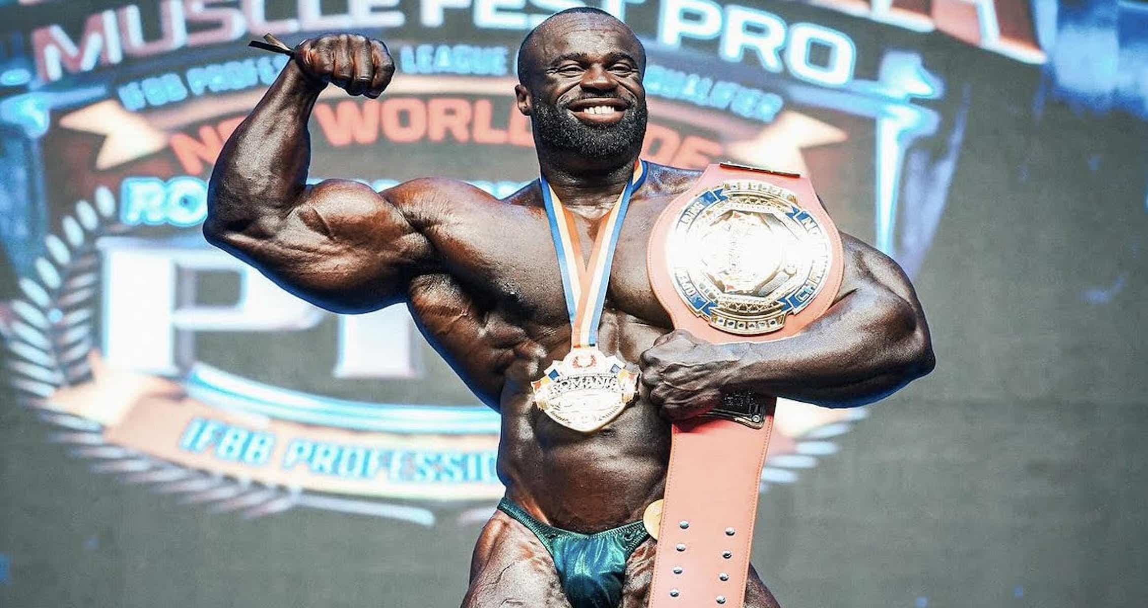 Samson Dauda poses with belt after his victory during the Romania Muscle Fest Pro on Sunday.