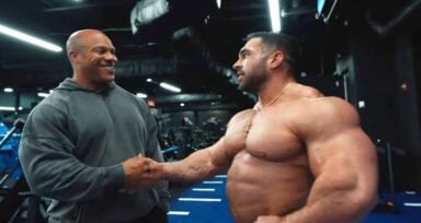 Phil Heath shares posing tips with Derek Lunsford as shorter bodybuilders.